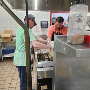 Brandon volunteering in the kitchen for a community event