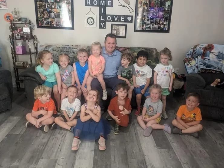 Brandon with a group of kids at a community gathering