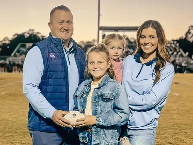 The Pharr family at the football field in Mc-Wright branded gear