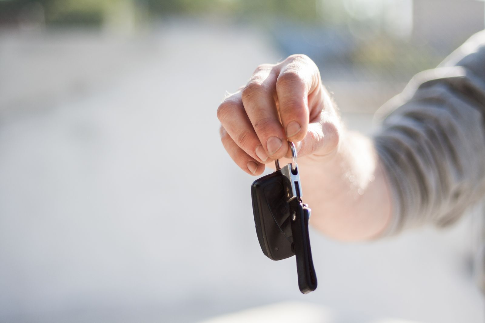 A person handing over a set of car keys
