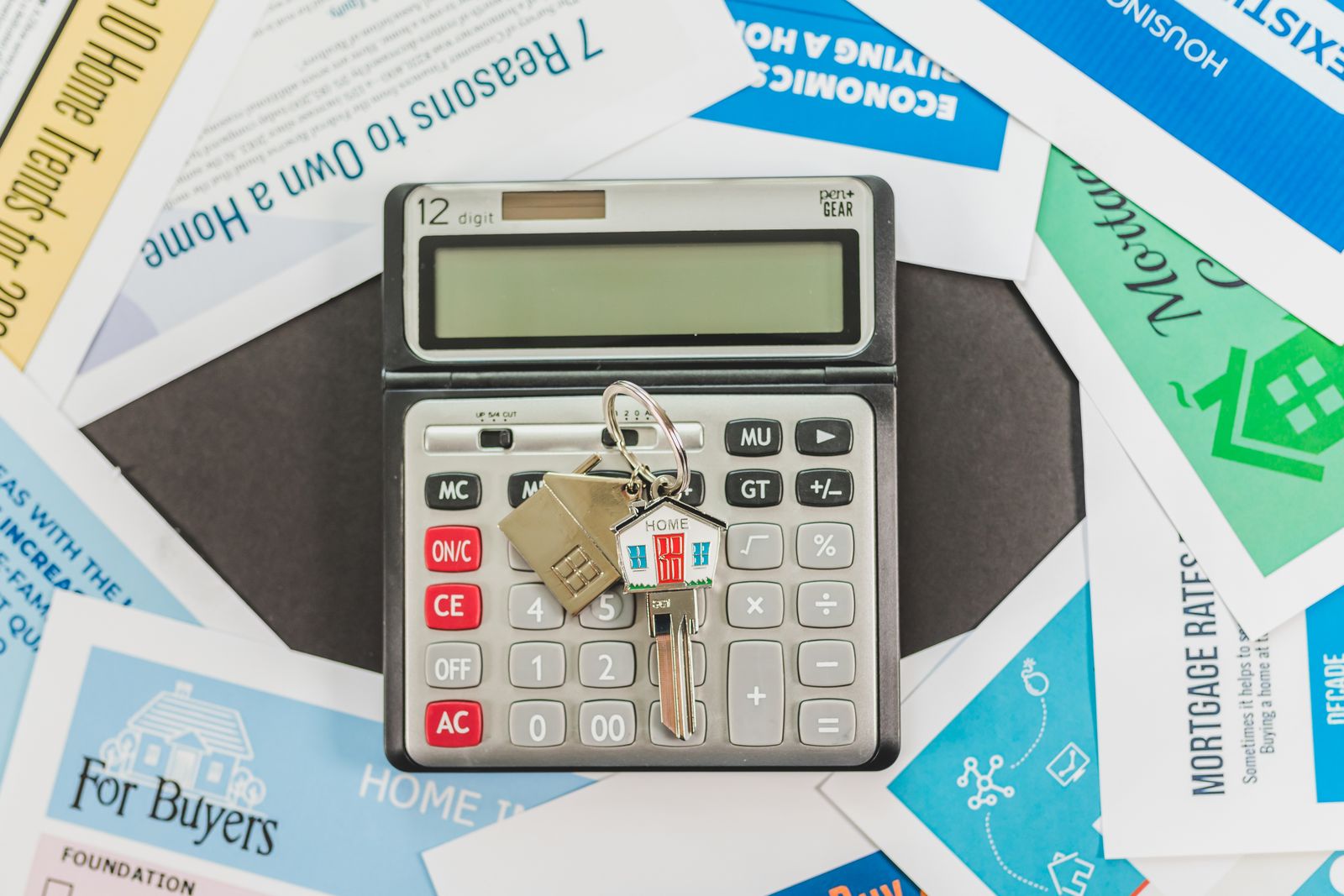 A calculator resting on a table next to paperwork