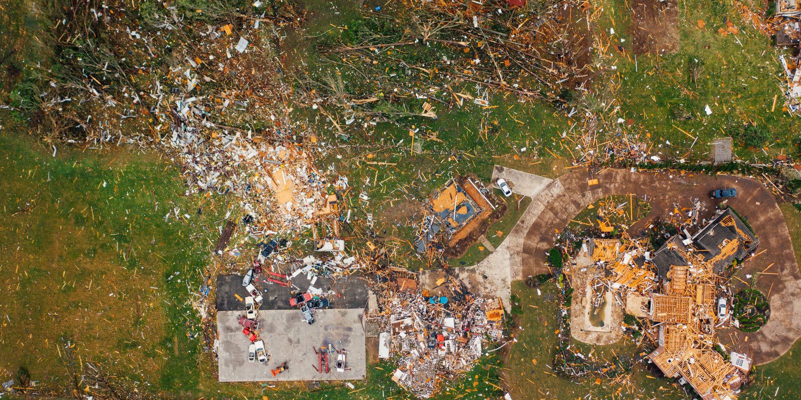 A neighborhood street littered with storm debris