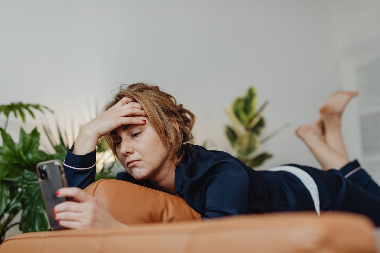 A stressed woman looking at her phone