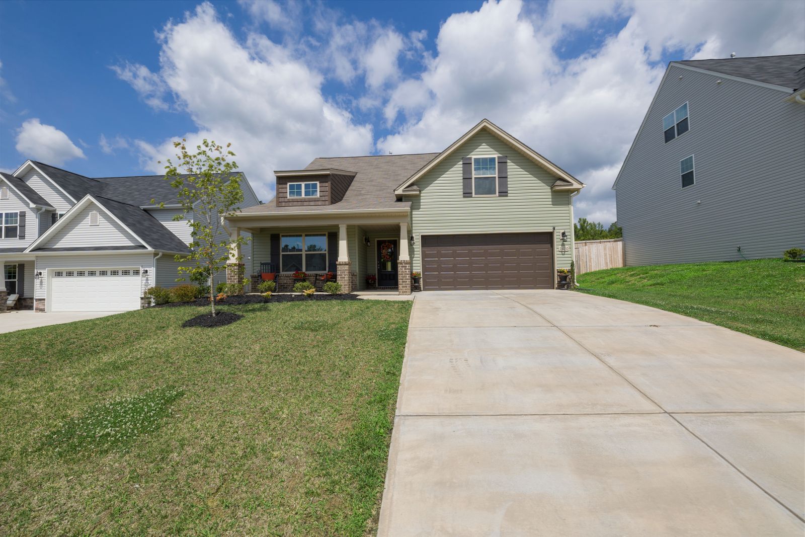 A modern suburban house with a driveway under a clear sky