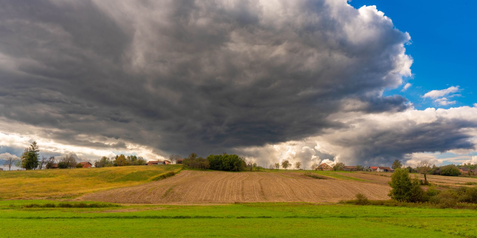 Dark storm clouds building over open country