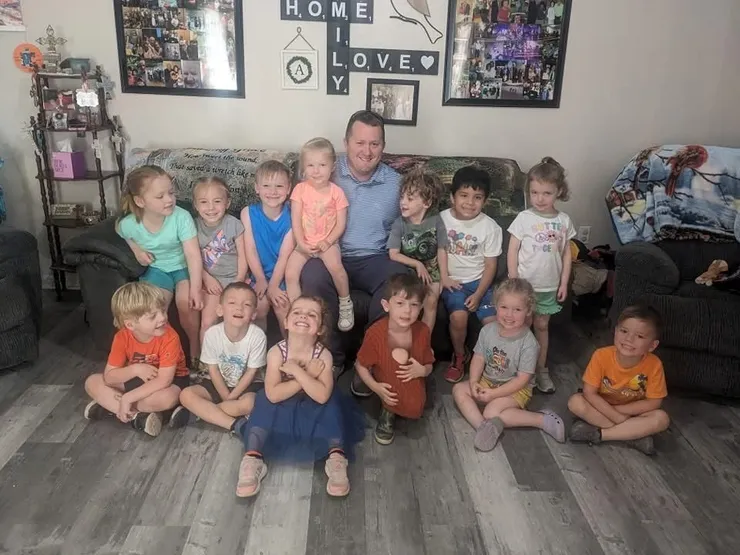 Brandon with a group of kids at a community gathering