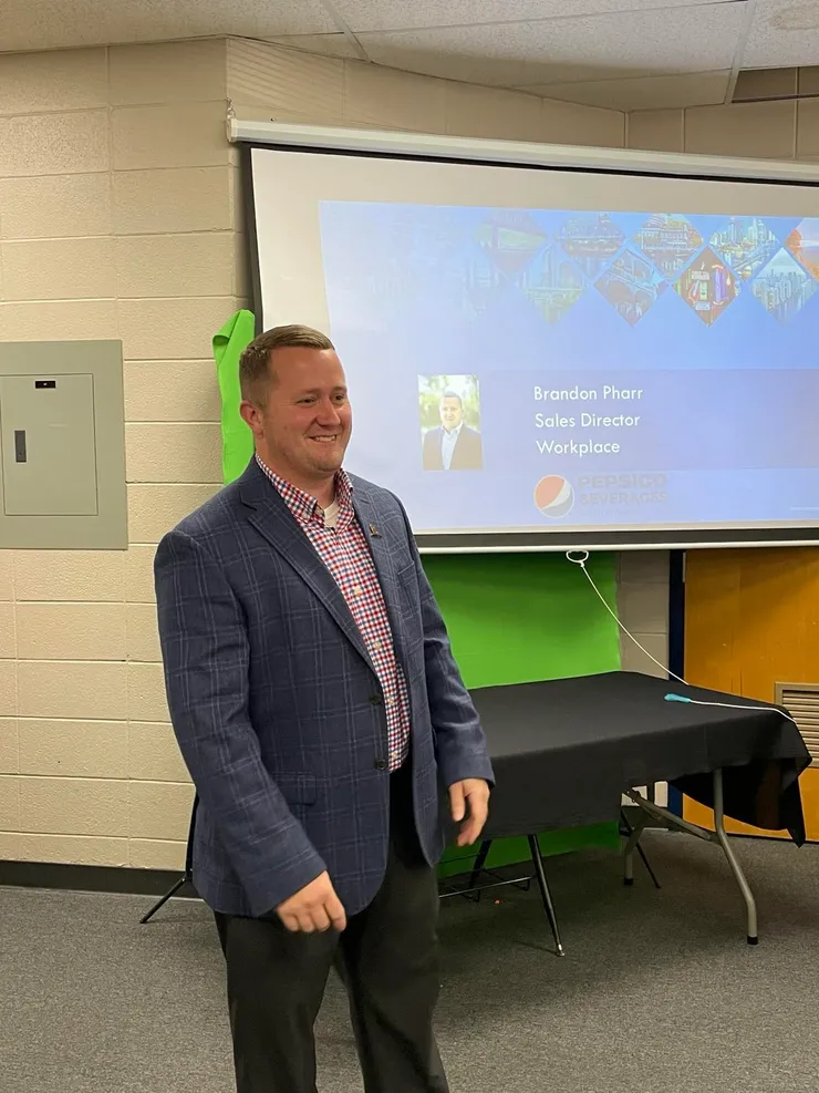 Brandon presenting to students in a classroom